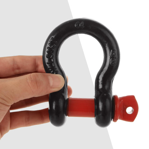Hand holding a single black and red shackle from Six Piece Five Eighths Inch D Ring Shackles Heavy Duty Screw Pin Clevis For Towing And Off Road Recovery, Working Load Limit 3.25 Ton, Break Strength 13 Ton, Set Of Six.