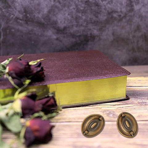 Six Pcs Oval Retro Brass Drop Swing Furniture Drawer Pulls With Screws Antique Bronze Finish next to closed book and dried roses.