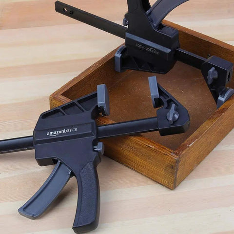 Six Piece Easy To Use One Handed Trigger Clamp Set With Four Inch And Six Inch Clamps In Black And Grey on wooden surface