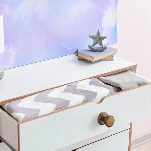 Open dresser drawer with an Antique Brass Cabinet Knob 6 Pack With Spacers And Backplates, vintage style hardware.