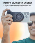 Person using Magnetic Phone Stand Camera Grip With Wireless Charging And Bluetooth Shutter For iPhone, ergonomic for selfies.