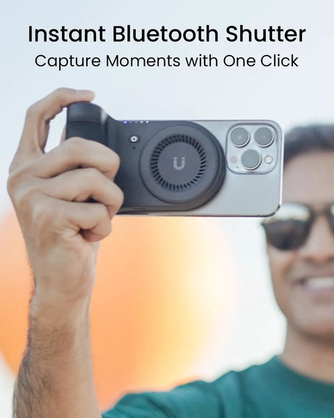 Person using Magnetic Phone Stand Camera Grip With Wireless Charging And Bluetooth Shutter For iPhone, ergonomic for selfies.