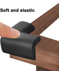 Built Tough Yet Soft Black Foam Corner Protectors Four Pack Pre Taped Rubber Edge Guards For Beds Tables And Desks on a table corner.
