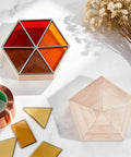 Hella Reliable Wood And Glass Soldering Jig Set Featuring Hexagon And Pentagon Molds on a surface with stained glass pieces