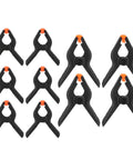 Top Tier 10 Piece Spring Clamps For Woodworking And DIY Projects With Ergonomic Handles That Grip Hard To Hold Boards Securely While You Paint Build Crafts Or Work In Your Studio Without Any Slip Ups On This Ultimate Hand Tool Kit., 10 black spring clamps with orange tips on white background