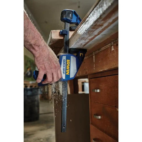 Heavy Duty One Hand Bar Clamp For Woodworking And Shop Fixes With Quick Toggle Spreader Mode and Grippy Pads in use, applying pressure on wood.