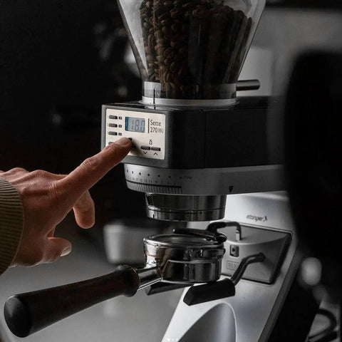 Close-up of the Straight Fire Conical Burr Coffee Grinder featuring Precision Grind By Weight Tech, showing the display and portafilter.