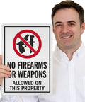 Straight Talk For Your Property With This Built Tough 14X10 Inch Rustproof Aluminum Yard Sign that shows No Firearms or Weapons Allowed.