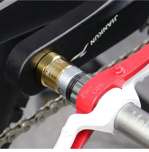Close-up of black and gold Pair Of Steel Bike Pedal Extenders For A Slight Crank Reach Upgrade With Sixteen Millimeter Spacer