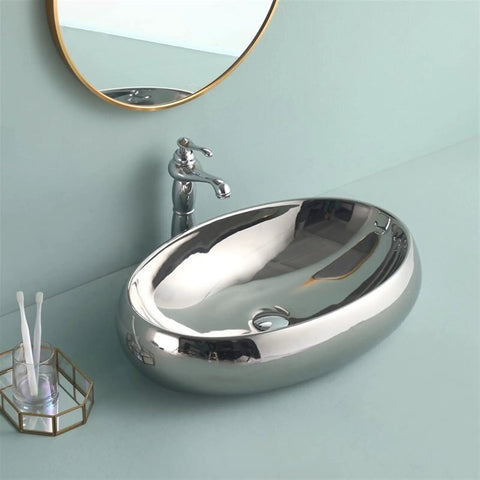 USZWBY Bathroom Vessel Sink European Ceramic Sink Art Basin Chrome Wash Basin Oval Sink close-up with faucet in silver.