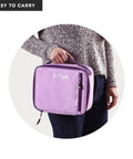 Keep Your Grub Fridge Cold All Day With This Straight Up Sweet Soft Sided Lunch Bag Featuring Double Ice Packs For Office Grind School Runs And Weekend Adventures In Smooth Lavender, held by a person.