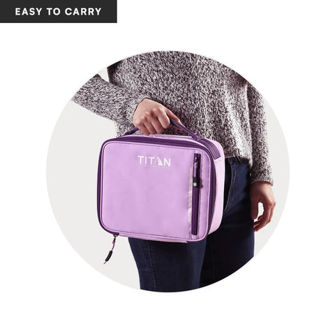 Keep Your Grub Fridge Cold All Day With This Straight Up Sweet Soft Sided Lunch Bag Featuring Double Ice Packs For Office Grind School Runs And Weekend Adventures In Smooth Lavender, held by a person.