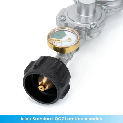 Close-up of propane regulator with gauge and black knob; brass gauge, silver body, QCC1 inlet.