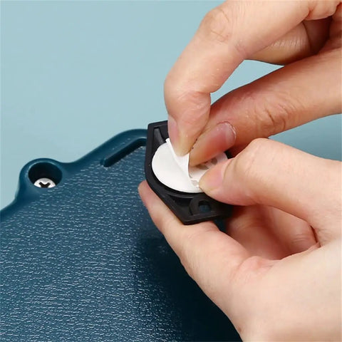 Heavy Duty Self Adhesive Furniture Casters With Stainless Steel Swivel Rollers showing the removal of adhesive backing for installation.