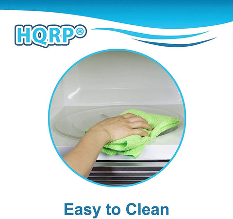 Person cleaning a 12-3/8 Inch Glass Microwave Turntable Tray Replacement Fits GE General Electric Hamilton Beach Frigidaire Emerson Oster Magic Chef Panasonic Ovens 315mm 12.375 Inch Plate for Even Cooking and Easy Cleanup with a green cloth.