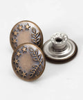 Close-up of 20 Sets Of 17mm Replacement Jeans Buttons Snap Kit With Metal Rivets For Jeans Denim Pants No Sew Button Replacement Durable Riveted Button Set For Quick Fixes, showing bronze decorative pattern and silver base.