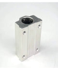 Linear bearing block in silver aluminum, angled front view showing side mounting holes and top bearing bore.