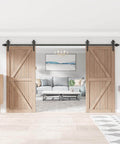 Black Wood Double Sliding Barn Door Hardware Kit With Big Spoke Wheel Rollers, visible in a modern interior setting.