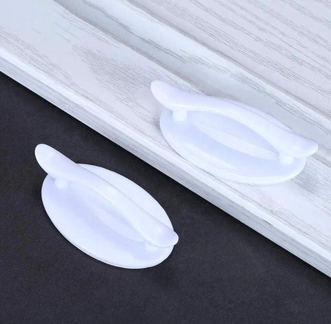 Four Pack Peel And Stick Drawer Pulls Easy Grip Handles For Cabinets And Doors No Glue Needed Self Adhesive White 1.9 By 3.2 Inches Fits Glass Tile Stainless Steel Wood Surfaces. White ABS self-adhesive drawer pull on cabinet door