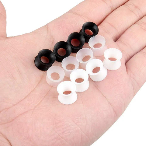Hand holding 0G Ear Tunnels Kit Ultra Thin Silicone Flesh Flexible Gauges Set Of 6 Pairs Clear White Black For Piercing Expansion Plugs