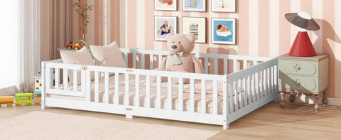 Full Size Floor Bed With Fence And Door For Toddlers And Kids in a nursery, with safe guardrails, wooden platform, white finish, teddy bear on bed