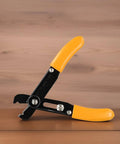 Adjustable Wire Stripper For 10-22 Awg Heavy Duty Manual Cable Cutter With Induction Hardened Edge Precision Stripping Tool For Electrical Wiring Jobs Orange And Black 130Mm Handle Design shown from side angle on wooden surface.