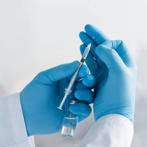 1 Ml Syringe With 31G Five Sixteenth Inch Needle Pack Of 30 Individually Wrapped Lab Tools For Quick Readouts And A Smooth Plunger Clear Scale And Airtight Inner Wall Perfect For Lab Work Medical Demos Or At Home Experiments. gloved hands holding 1 mL syringe with clear scale
