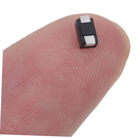 Hella Reliable 100 Piece SMD Rectifier Diode Pack Built Tough For High Voltage Circuits, small diode shown on fingertip.