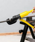 Heavy Duty 22mm Hydraulic Rebar Cutter With Sturdy Steel Toolbox For Construction Sites cutting through steel rod on a workbench.