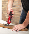 Man using Pivot Grip 4V Rechargeable Cordless Screwdriver With 9 Bits, Bit Holder, And USB Charger for DIY home repair on wood.