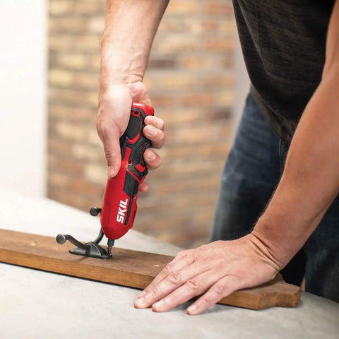 Man using Pivot Grip 4V Rechargeable Cordless Screwdriver With 9 Bits, Bit Holder, And USB Charger for DIY home repair on wood.