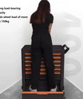 Person standing on 7-Drawer Rolling Tool Cart On Wheels With Lock Mobile Tool Storage Organizer For Garage And Workshop Durable Cold-Rolled Steel Tool Box For Home Repairs And Heavy Duty Projects showing weight capacity.