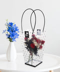 Plastic Flower Bouquet Bag With Handle For Floral Arrangements And Weddings on table with roses and blue flowers