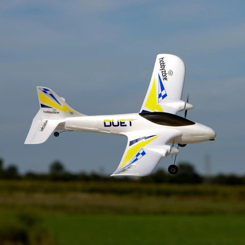 RC Airplane Duet S 2 Ready To Fly Starter Kit with everything included in flight above grass field HBZ05300