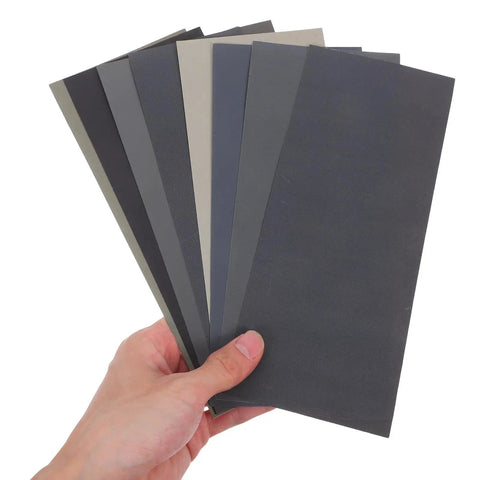 56pc Wet And Dry Sanding Kit With Multi Grit Sheets 400 To 5000 Grit Carborundum Paper for Metal and Plastic in hand view