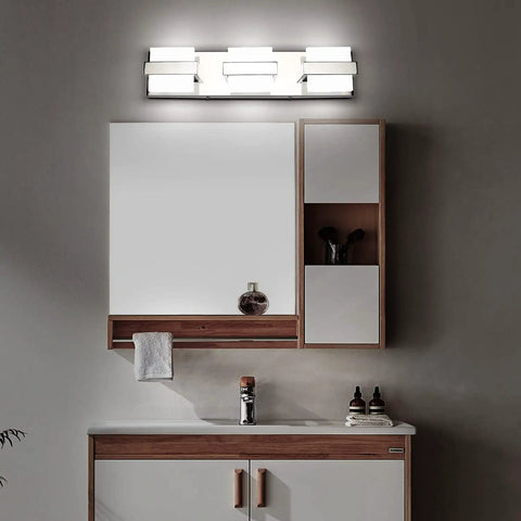 Modern Three Light Chrome Bathroom Vanity Light Over Mirror Super Easy Fifteen Minute Install Led Fixture Twenty Inch Size Bright White Light Non Dimmable For Your Home Bathroom above a wooden bathroom vanity.