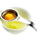 Stainless Steel Egg Separator And Yolk White Filter No Mess Kitchen Gadget with egg yolk held above bowl with whites
