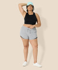 Model wearing Women's Regular Fit Athletic Woven Running Shorts With Ruched Waistband, Zip Pocket, Breathable Lightweight Fabric, Gray Heather, Size Medium