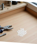 Anchor-Shape LED Strip Clips White Plastic Mounting Brackets For LED Light Strips on a wooden workbench