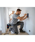 Electrician uses Pro Grade Wall Scanner For Electricians And Contractors All In One Multi Function Stud Finder on wall