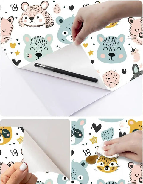 Slick Pastel Woodland Peel And Stick Wallpaper With Cute Animal Head Prints being applied with a pen and smooth tool for neat installation.