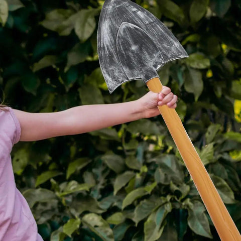 Child holding one piece of Two Piece Foam Pickaxe And Shovel Props For Mine Cosplay Party Decor Lightweight Plastic And Sponge Stage Props Dope Photo Op Props Safe Realistic Look For Fun Themed Events.