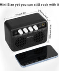 Black Guitar Mini Amp 5W Rechargeable Bluetooth Amplifier with control knobs for desktop practice next to smartphone for scale.