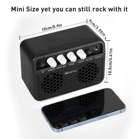 Black Guitar Mini Amp 5W Rechargeable Bluetooth Amplifier with control knobs for desktop practice next to smartphone for scale.