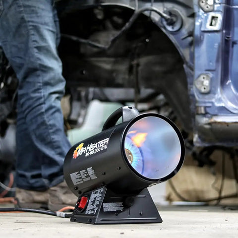 60,000 BTU Portable Propane Forced Air Heater With Quiet QBT Technology in use, heating a workshop space.