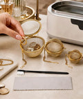 Slick All In One Jewelry Cleaning Kit Featuring Three Stainless Steel Ultrasonic Baskets and detail brush on a table.