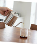 Pouring coffee from a Smooth Pour Long Spout Coffee Kettle With Lid Stainless Steel Tea Pot for home brewing.