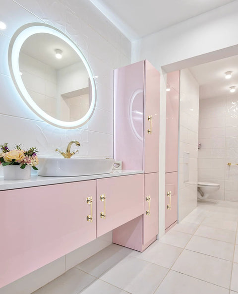 Modern bathroom with pink cabinets featuring 2 Pack 5 Inch Self Stick Cabinet Handles With Adhesive Gold Metal Drawer Pulls installed.