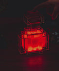 Potion Bottle Color Changing LED Desk Lamp With Pixelated Design, 7 Inch Night Light glowing red, positioned on a desk.