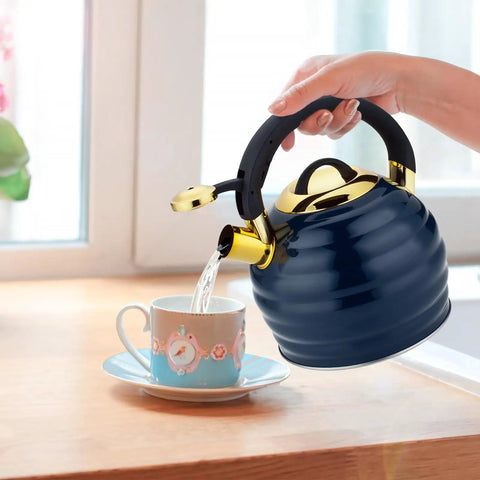 Stovetop Whistling Tea Kettle 3.2 Quart Stainless Steel Teakettle With Heat Proof Ergonomic Handle pouring into a teacup